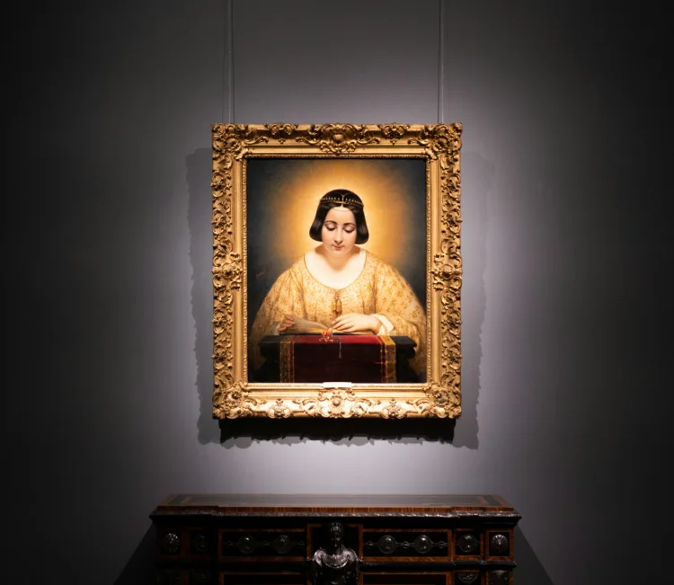 A painting of a woman in a gold frame.