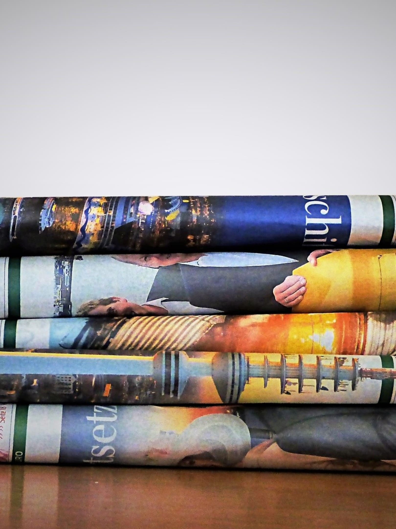 A stack of magazines with different covers on them.