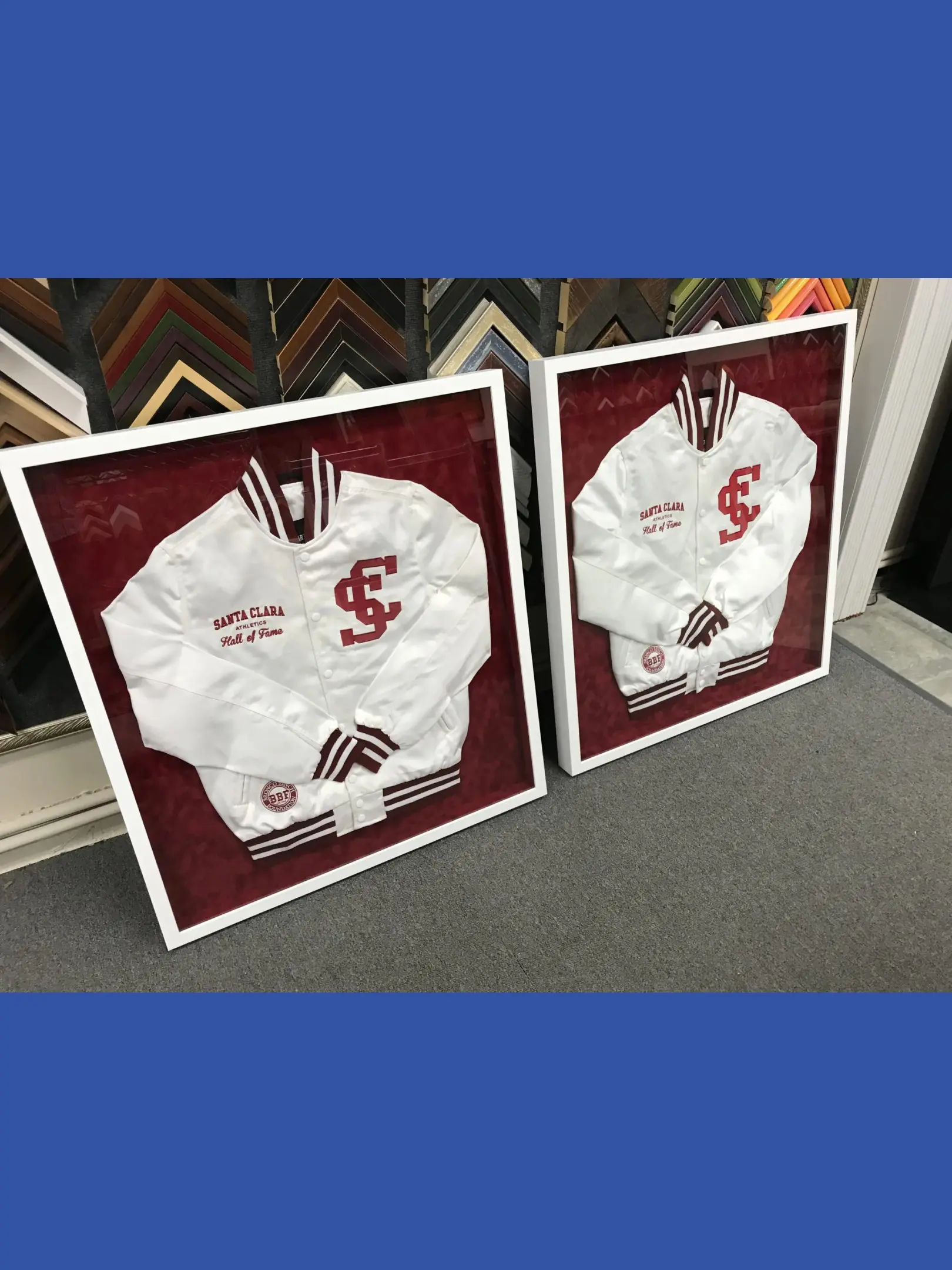 Two framed jackets are sitting on the floor.