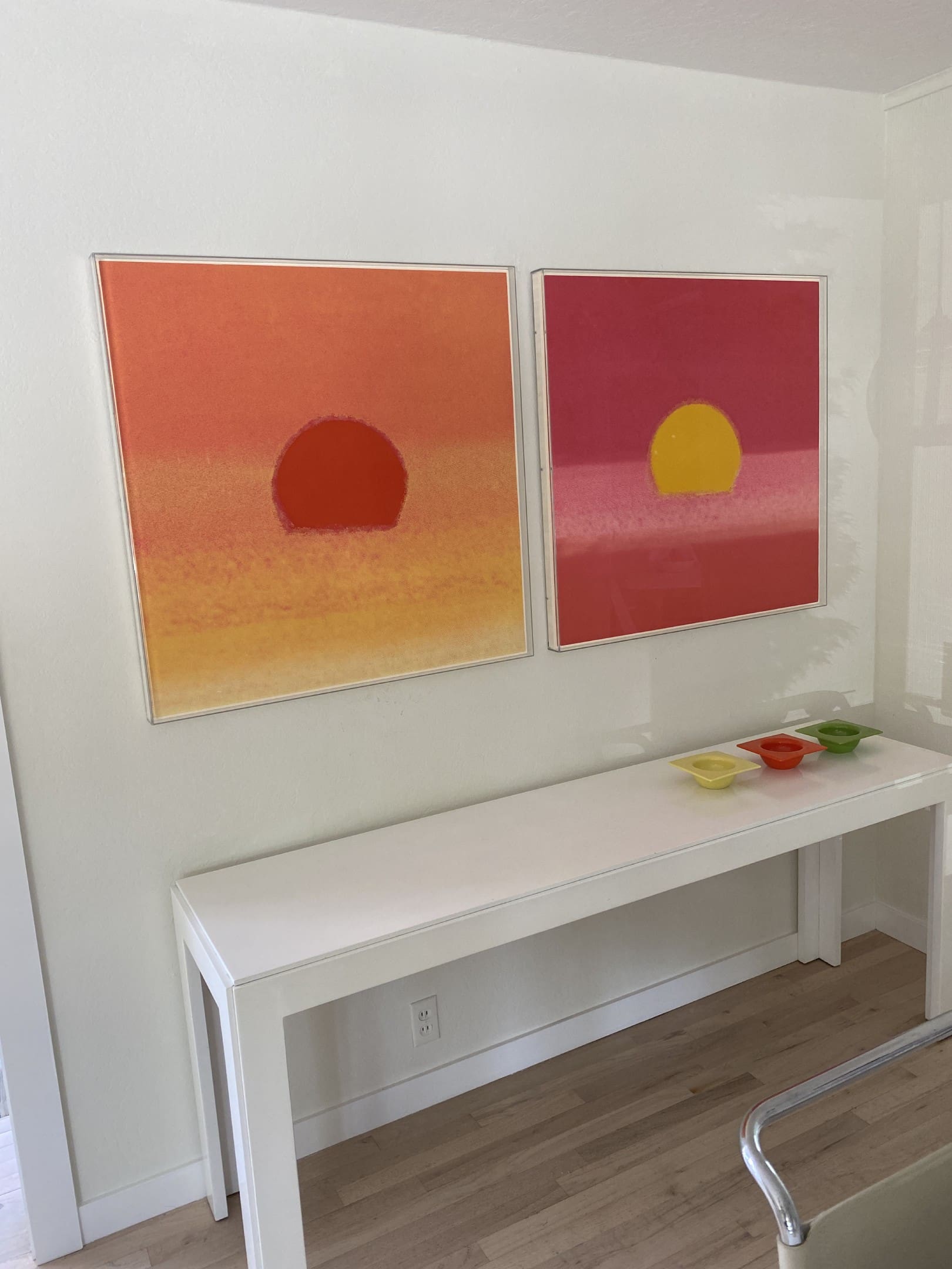 Two paintings of the sun on a wall