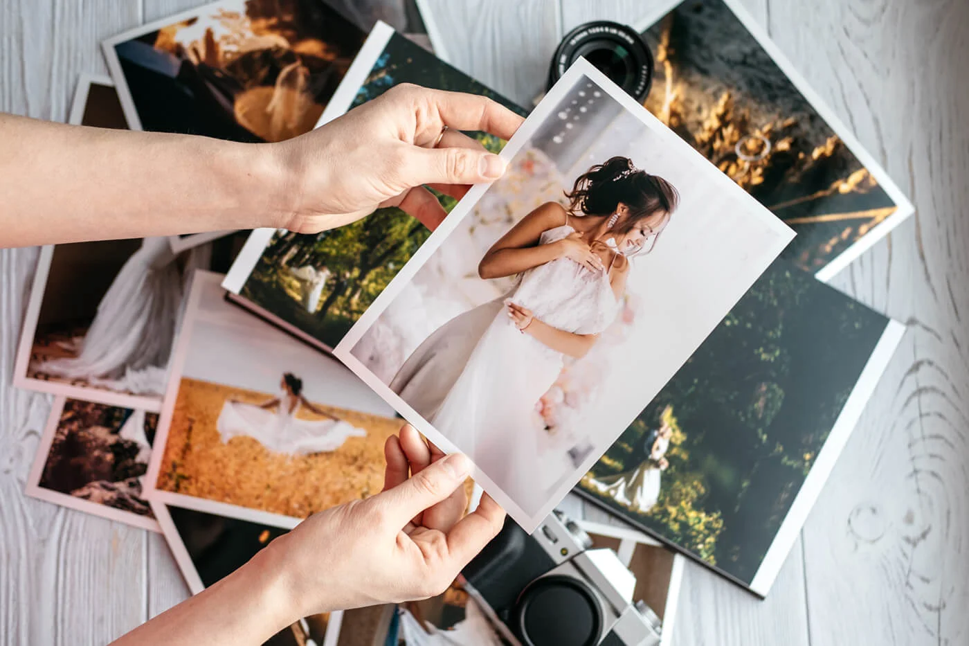 A person holding up a photo of a woman.