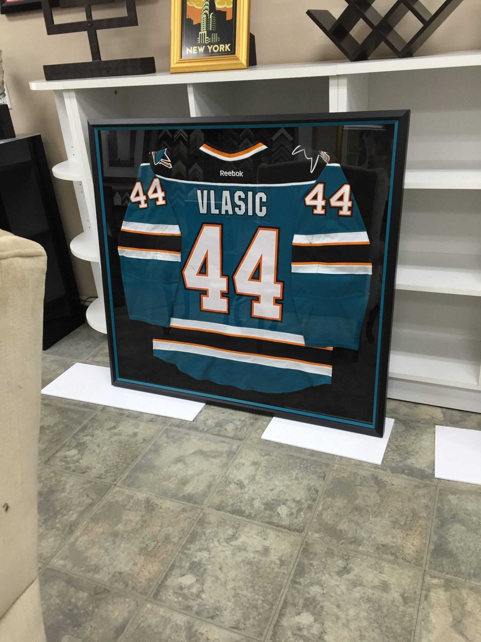 A hockey jersey is displayed in a frame.