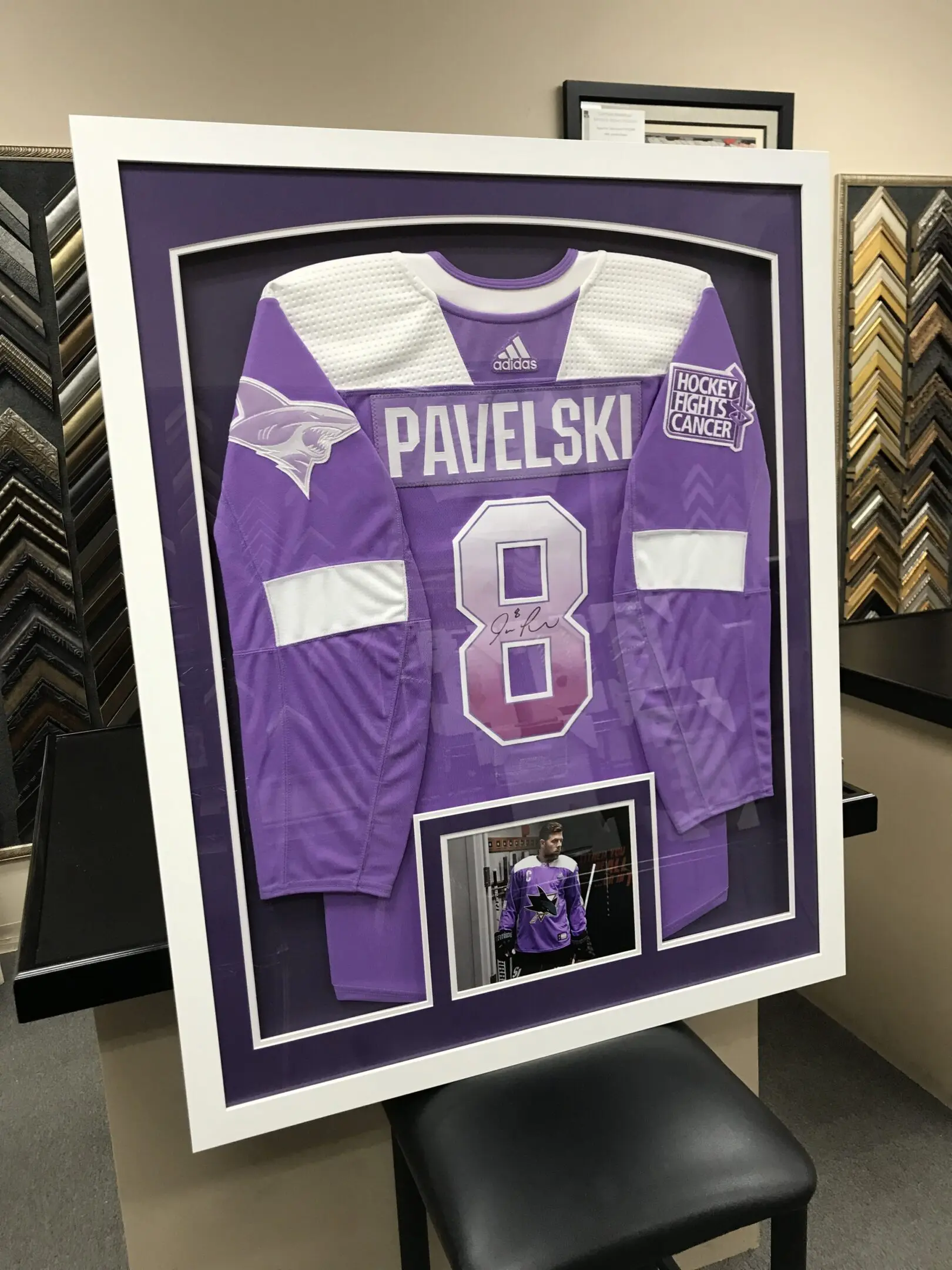 A framed jersey is displayed in the middle of a table.