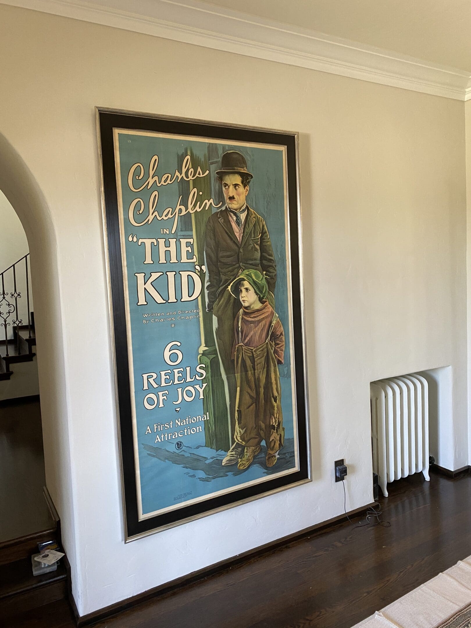 A large poster of chaplin is hanging on the wall.